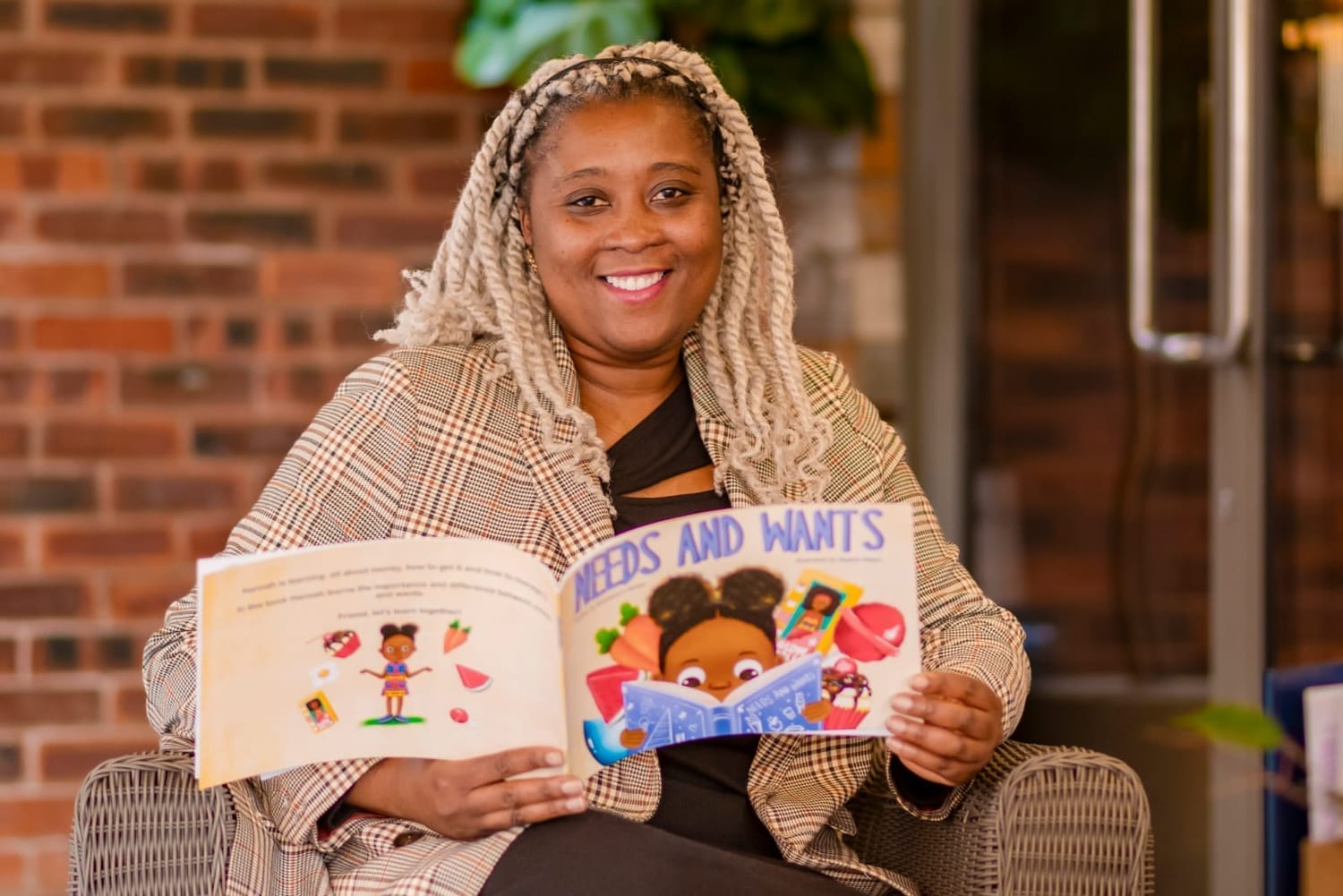 Rumbi Mutopo holding her children's book